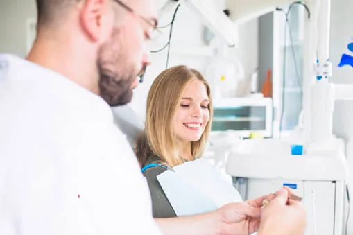 Dentist explaining porcelain crown options to patient