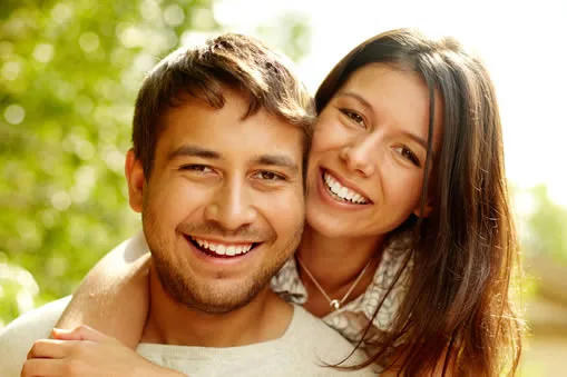 Happy couple smiling after dental bonding treatment