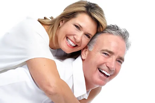 Happy mature couple smiling after All-on-4 dental implants