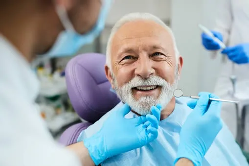 Patient receiving oral cancer screening at Roam Dental Shelby Township