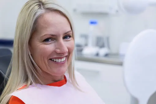 Mature woman at dentist discussing All-on-4 implant treatment