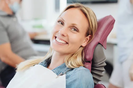 Woman smiling comfortably in dental chair at Roam Dental