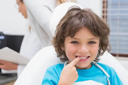 Young boy at dental office learning about teeth