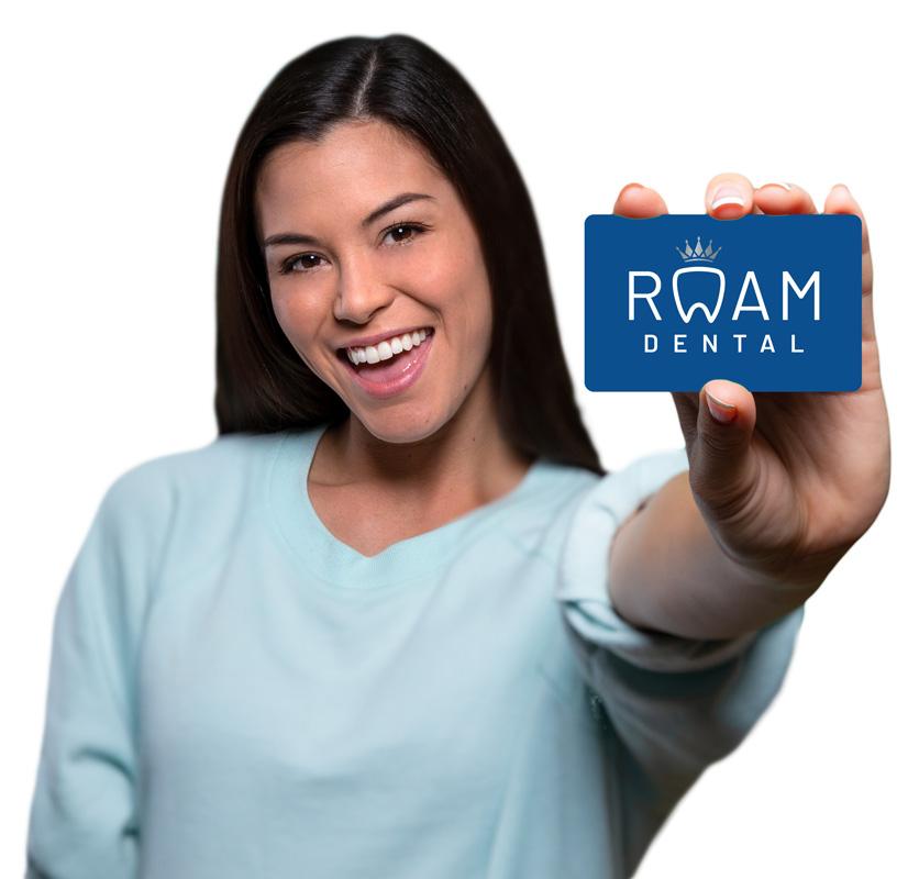 Smiling woman holding up a dental membership card